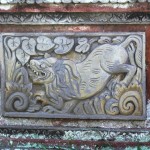 One of Lempad's small bas reliefs set into the low outside walls of the Bedulu cultural centre, Bali.