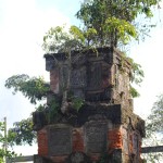 Trees grow out of Lempad's ruined kul-kul tower, Bedulu cultural centre, Bali.